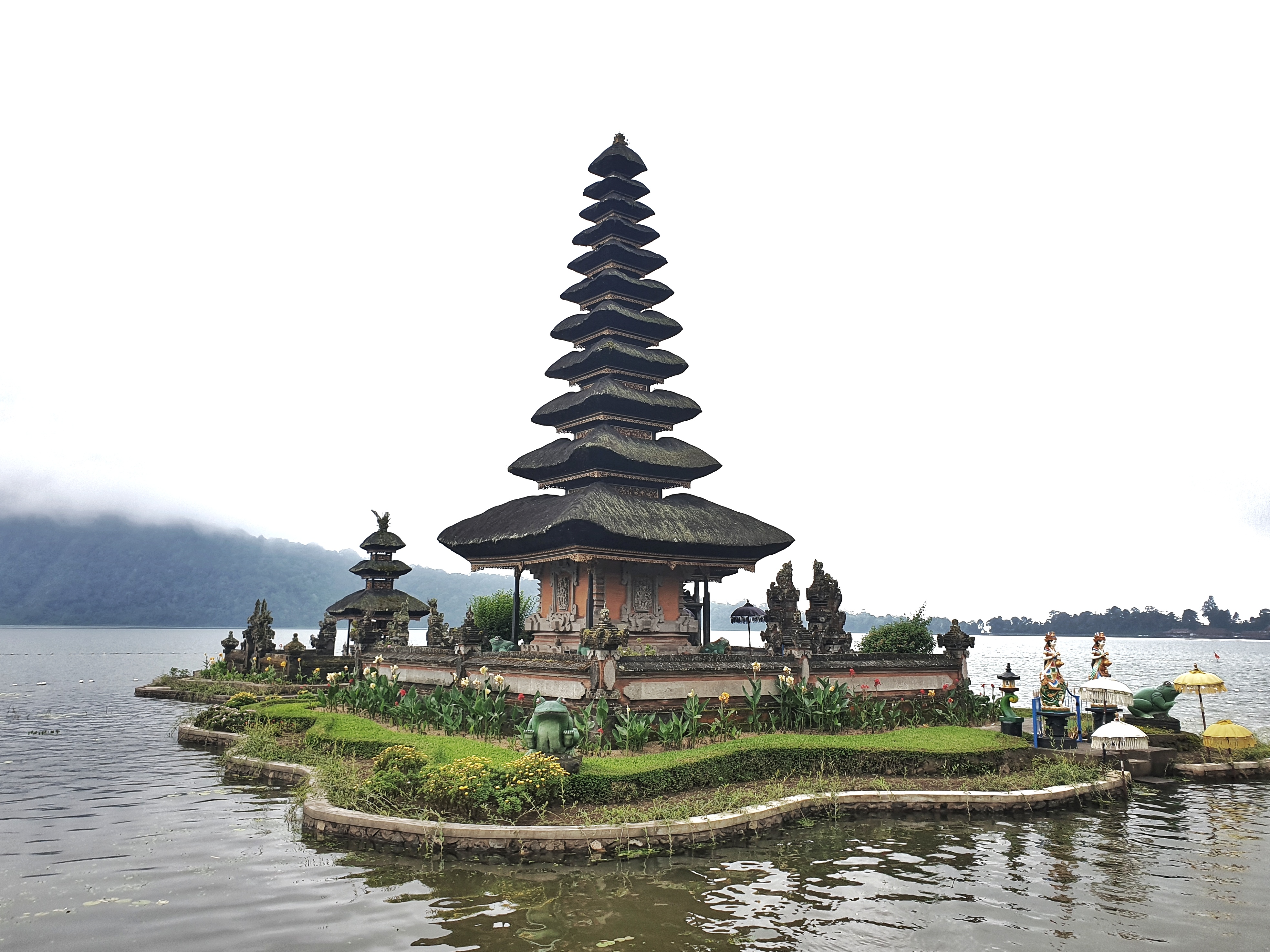 ‘the source temple of Lake Beratan’, is easily the island’s most iconic sanctuary sharing the scenic qualities with the seaside temples of Uluwatu and Tanah Lot. The smooth reflective surface of the lake surrounding most of the temple’s base creates a unique floating impression, while the mountain range of the Bedugul region encircling the lake provides the temple with a scenic backdrop.  Read more at: http://www.bali-indonesia.com/attractions/ulun-danu-beratan-temple.htm?cid=ch:OTH:001